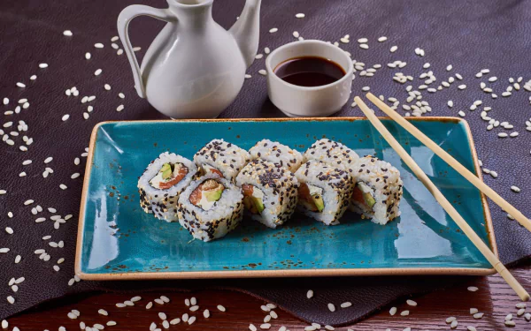HD PC desktop wallpaper and background: sushi rolls on a turquoise plate with scattered rice, wooden chopsticks, soy sauce and ceramic jug in a seafood still life.