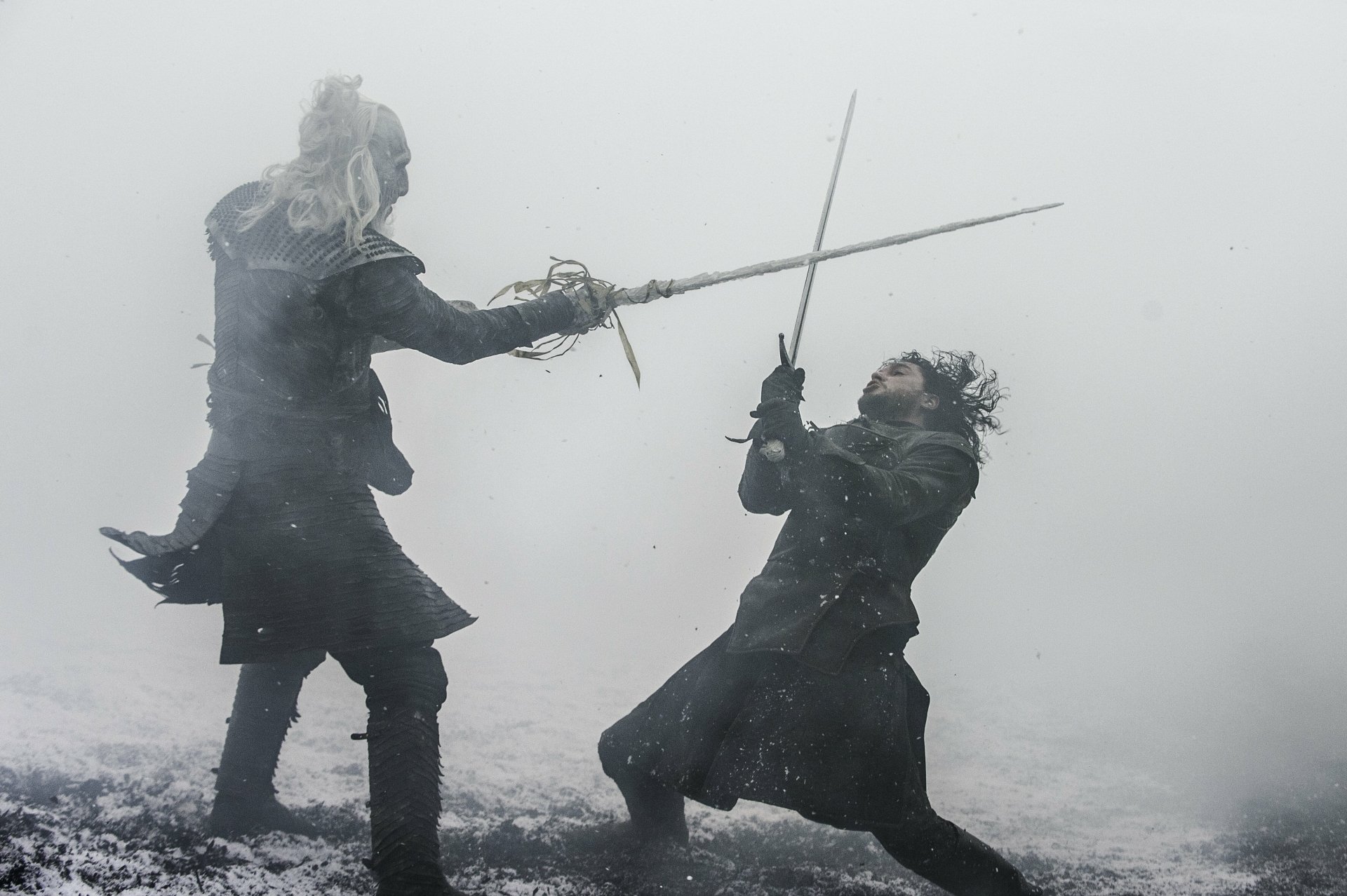 A dramatic scene from Game of Thrones featuring Jon Snow, played by Kit Harington, battling a White Walker in a snowy, misty landscape. This 4K Ultra HD wallpaper captures the tension of their encounter.