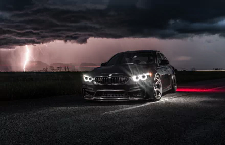 A black BMW M3 car parked at night under a stormy sky with lightning, captured in HD for a dramatic PC desktop wallpaper background.