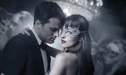 HD desktop wallpaper from Fifty Shades Freed featuring a man in a suit and a woman with a lace mask in a close embrace.