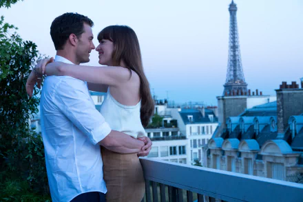 HD desktop wallpaper of a couple embracing with the Eiffel Tower in the background, from Fifty Shades Freed.