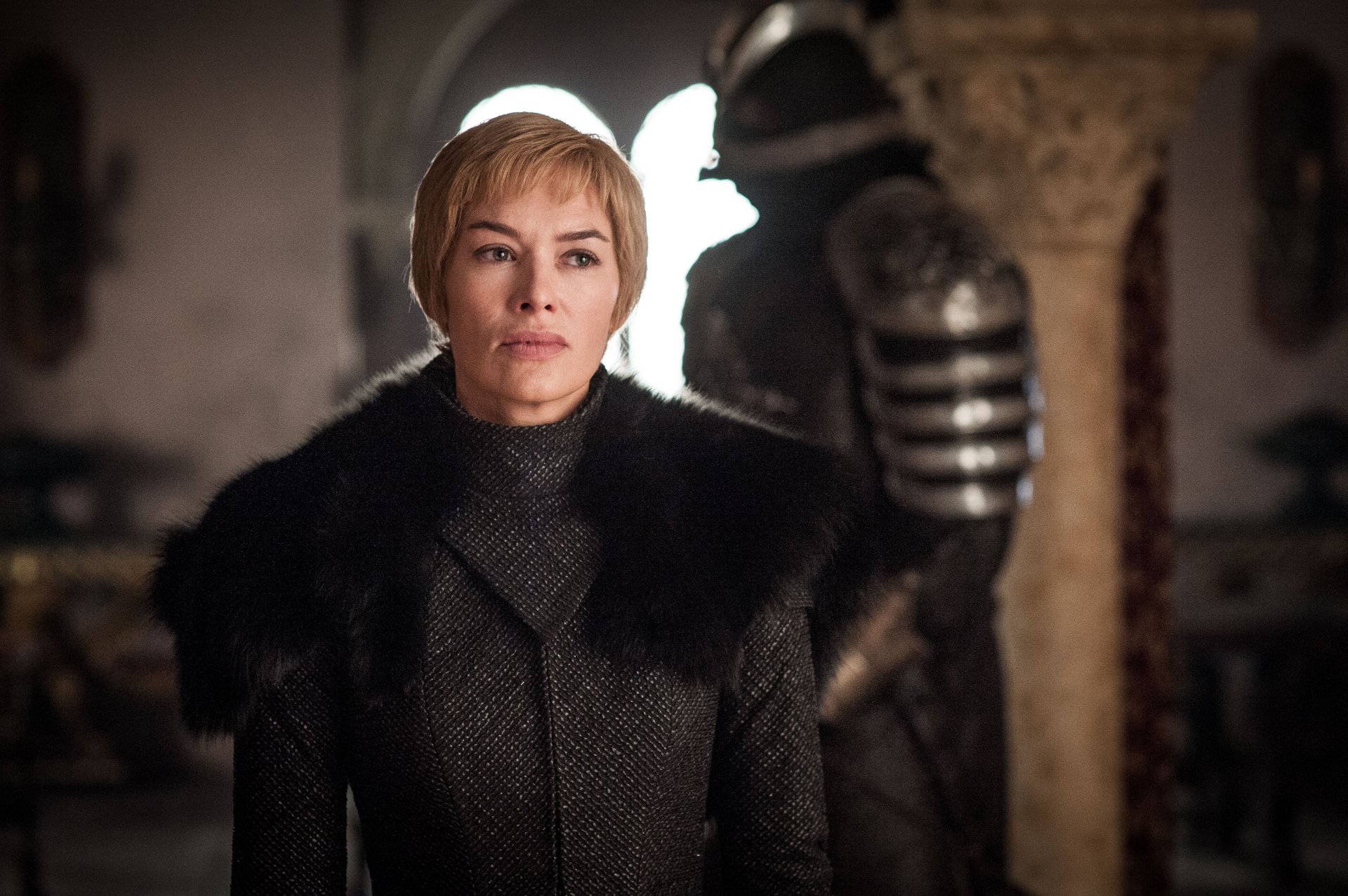 Regal woman in a fur-trimmed dark coat stands in a dim throne room — Game of Thrones TV scene rendered as 4K UHD desktop wallpaper.