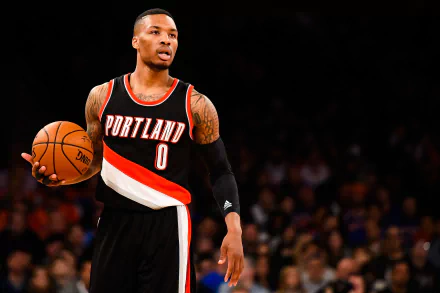 HD wallpaper of Damian Lillard in Portland Trail Blazers uniform dribbling on the basketball court.