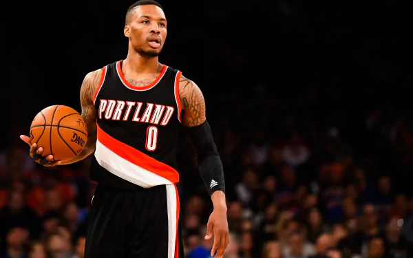 HD wallpaper of Damian Lillard in Portland Trail Blazers uniform dribbling on the basketball court.