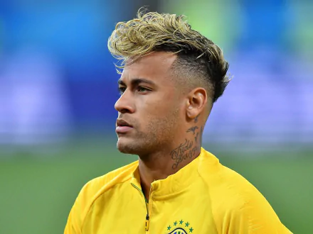 HD desktop wallpaper of Brazilian soccer star Neymar in a yellow jersey, captured in a focused moment during a sports event.