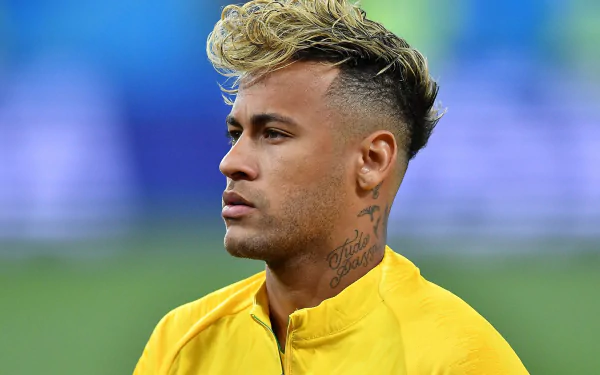 HD desktop wallpaper of Brazilian soccer star Neymar in a yellow jersey, captured in a focused moment during a sports event.