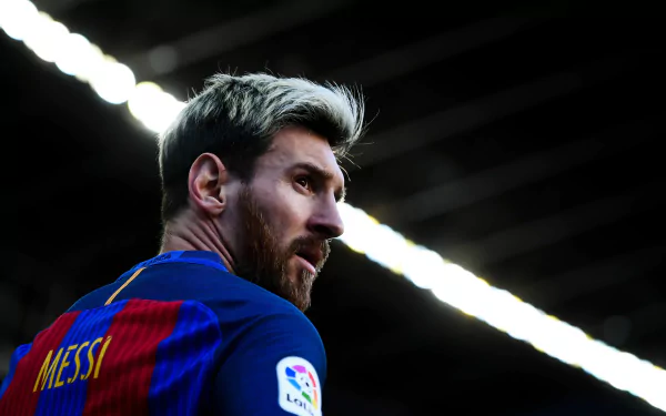 HD desktop wallpaper featuring Argentinian soccer player Lionel Messi, showcasing his profile in a sports setting, with his name visible on the back of his jersey.