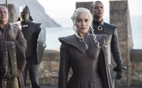Daenerys Targaryen stands at Dragonstone flanked by Grey Worm and Lord Varys; Game of Thrones TV show scene — 5K Ultra HD PC desktop wallpaper/background.