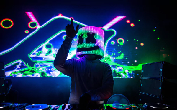 HD desktop wallpaper featuring DJ Marshmello performing with vibrant, neon lights in the background. The iconic Marshmello helmet glows under the dynamic light show, creating an energetic music atmosphere.