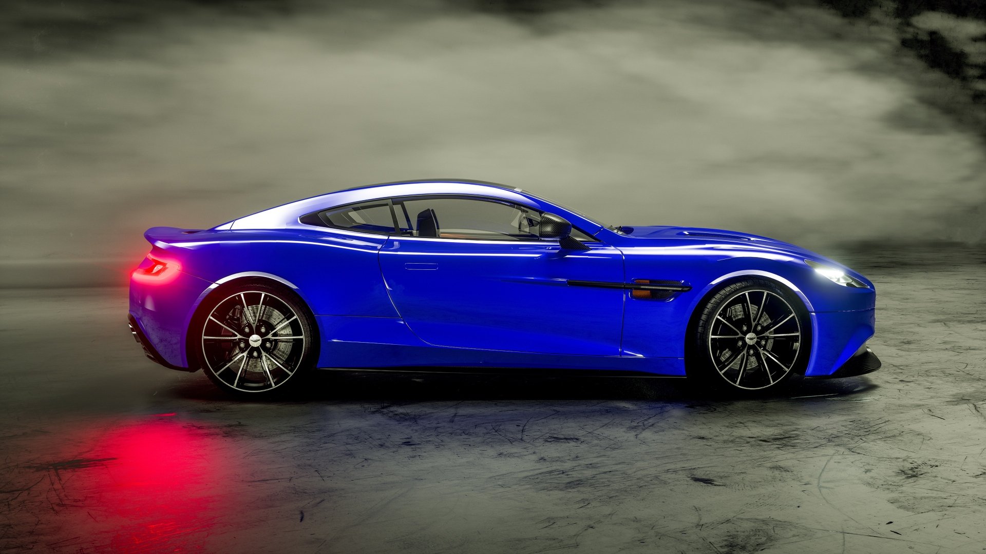 Profile of a blue Aston Martin Vanquish grand tourer supercar on a smoky studio floor, vivid 4K Ultra HD PC desktop wallpaper/background.