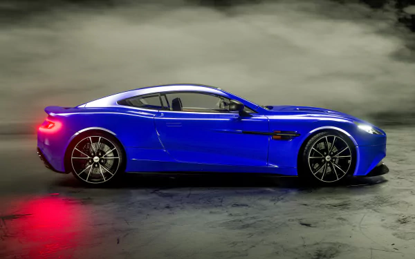 Profile of a blue Aston Martin Vanquish grand tourer supercar on a smoky studio floor, vivid 4K Ultra HD PC desktop wallpaper/background.