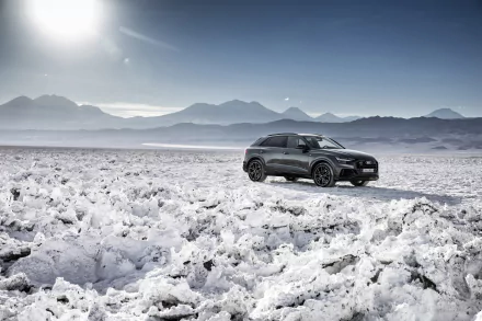 Silver Audi Q8 SUV parked on a snowy landscape under a bright sky, captured in stunning 4K Ultra HD for a high-resolution desktop wallpaper.