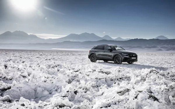 Silver Audi Q8 SUV parked on a snowy landscape under a bright sky, captured in stunning 4K Ultra HD for a high-resolution desktop wallpaper.
