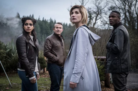 Jodie Whittaker as the Thirteenth Doctor stands with her companions in a misty wooded setting, featured in this 4K Ultra HD Doctor Who (2005) TV show wallpaper.
