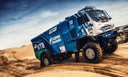 Kamaz rally truck racing through desert terrain during a high-intensity rallye event, captured in vivid 4K Ultra HD for a dynamic sports wallpaper background.