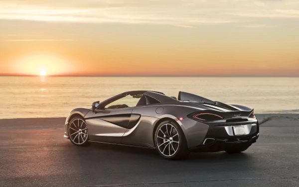 Silver McLaren 570S supercar parked near the ocean at sunset, captured in stunning 4K Ultra HD as a PC desktop wallpaper and background.