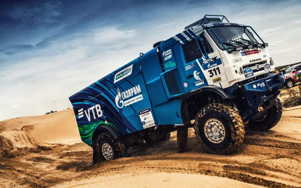 Kamaz rally truck racing through desert terrain during a high-intensity rallye event, captured in vivid 4K Ultra HD for a dynamic sports wallpaper background.