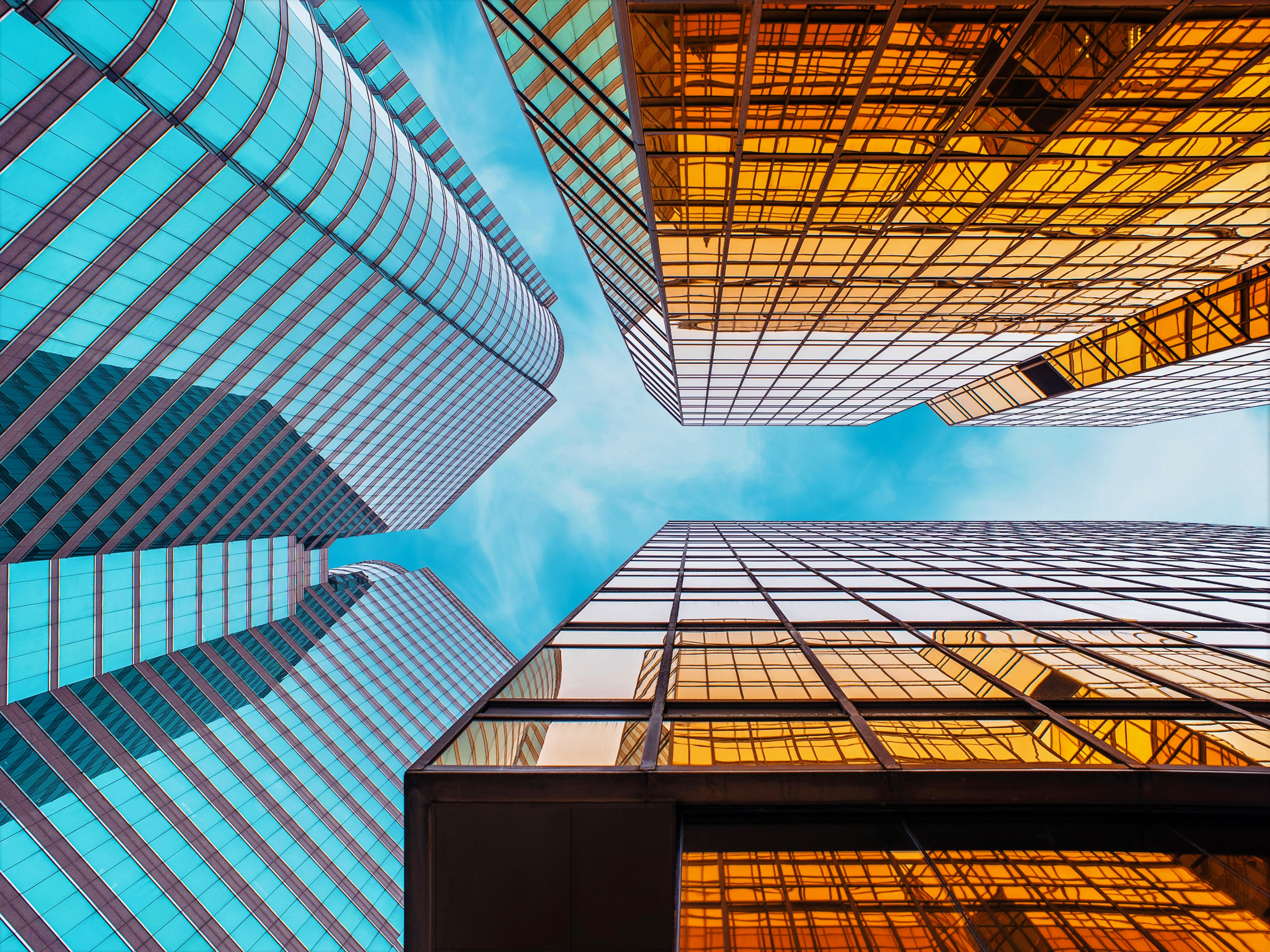 Reflective skyscrapers, business office buildings. low angle view of  skyscrapers in city, sunny day. Business wallpaper with modern high-rises  with mirrored windows. Generative AI 28297760 Stock Photo at Vecteezy