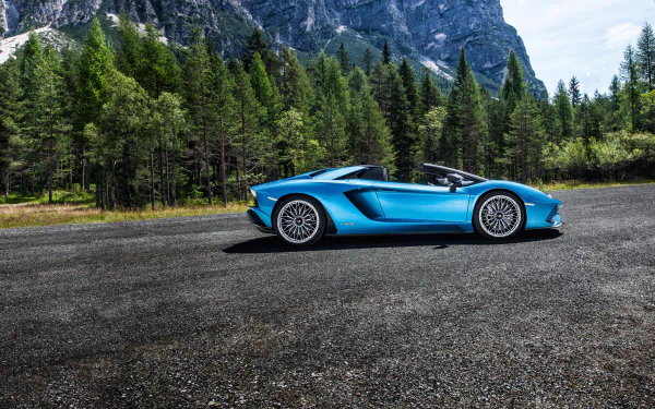 Blue Lamborghini Aventador S supercar (Lamborghini Aventador) — car/vehicle in side profile on a mountain road with forested peaks; 4K Ultra HD PC desktop wallpaper background.