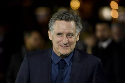 HD desktop wallpaper featuring a smiling individual at a nighttime event, suited for a sophisticated background.