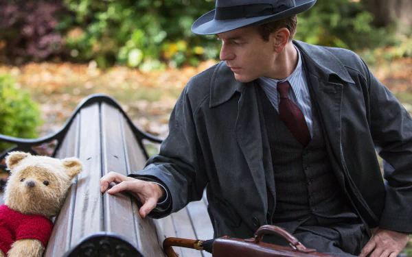 HD wallpaper featuring Christopher Robin and Winnie the Pooh on a bench, reflecting a heartwarming moment.