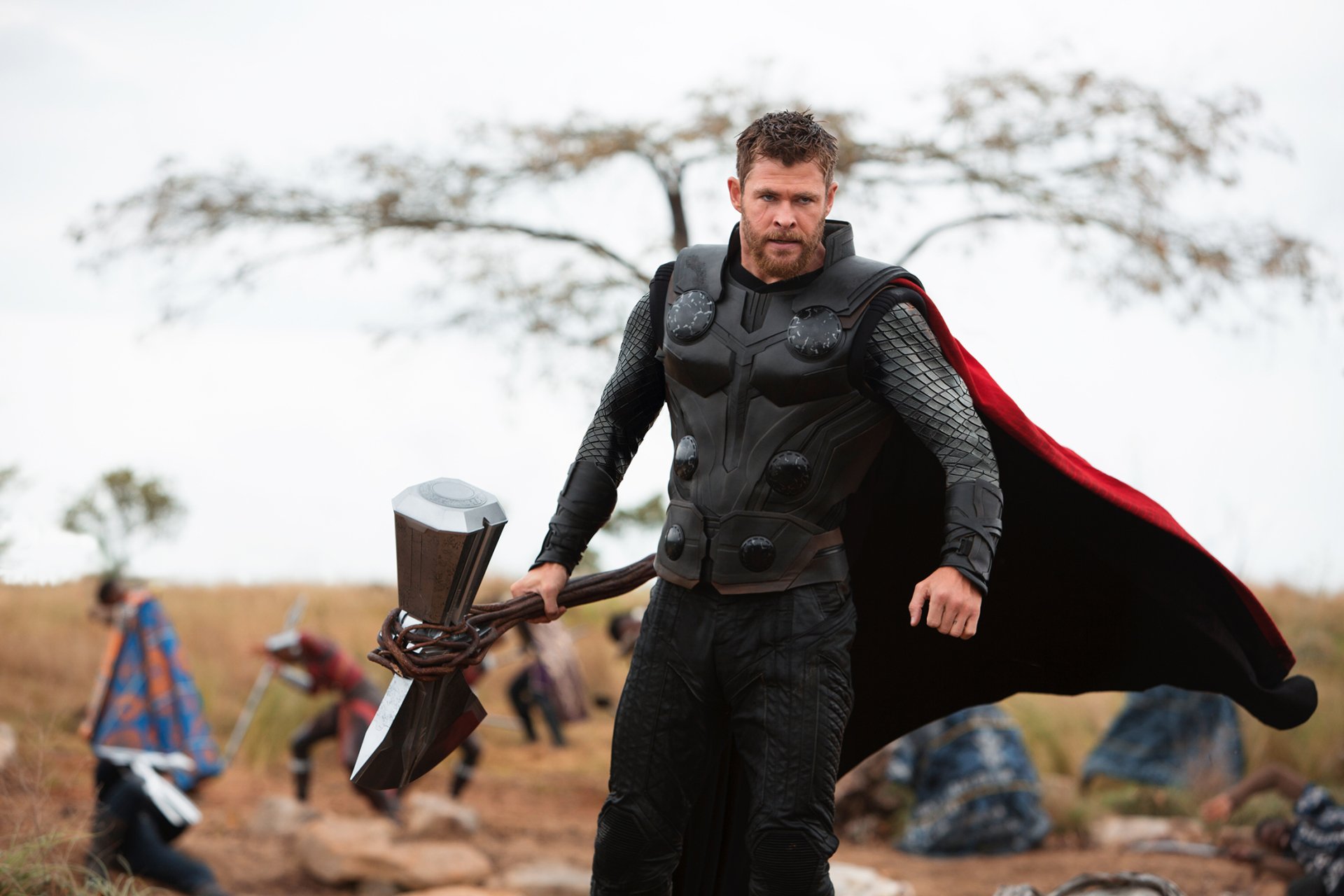 HD desktop wallpaper featuring Chris Hemsworth as Thor from the movie Avengers: Infinity War, wielding Stormbreaker with his red cape flowing behind him.