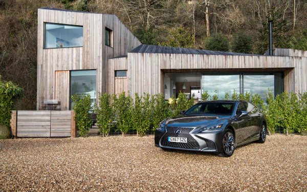 Silver Lexus LS sedan parked on gravel before a modern wooden house, 4K Ultra HD PC desktop wallpaper background.