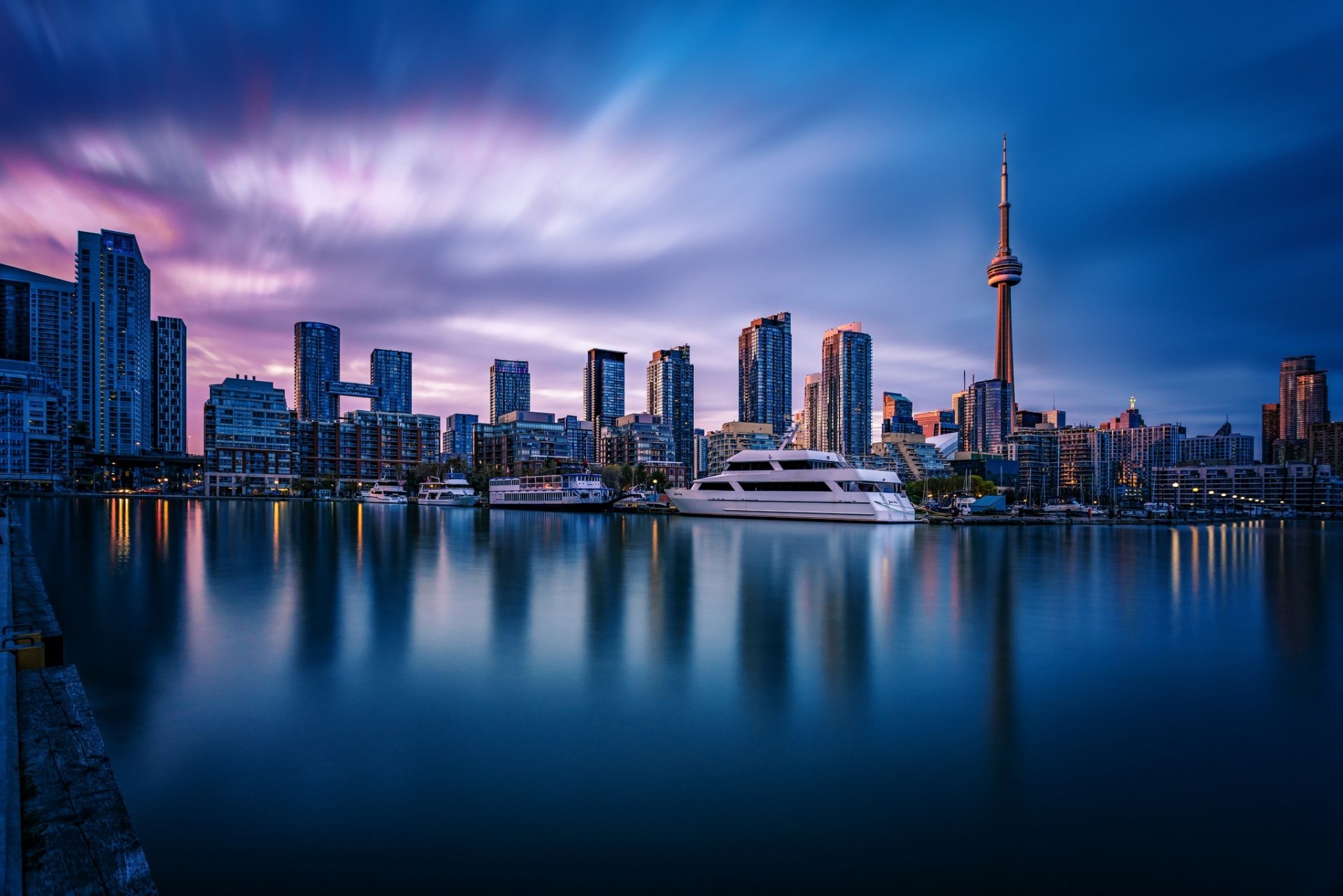 A mesmerizing cityscape of Toronto's stunning harbor with skyscrapers and iconic buildings, captured in high definition for a vivid desktop wallpaper.