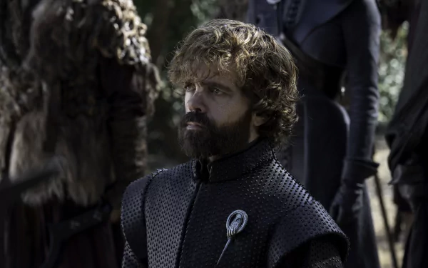 Tyrion Lannister (Game of Thrones) — bearded man in dark padded armor with a Hand brooch, gazing sideways amid cloaked figures; 5K Ultra HD TV-show PC desktop wallpaper.
