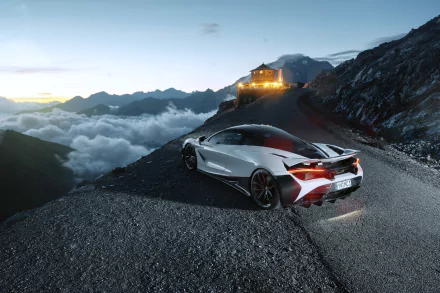 Silver McLaren 720S supercar parked on a mountain road at dusk, overlooking clouds and distant peaks, captured in stunning 4K Ultra HD detail.