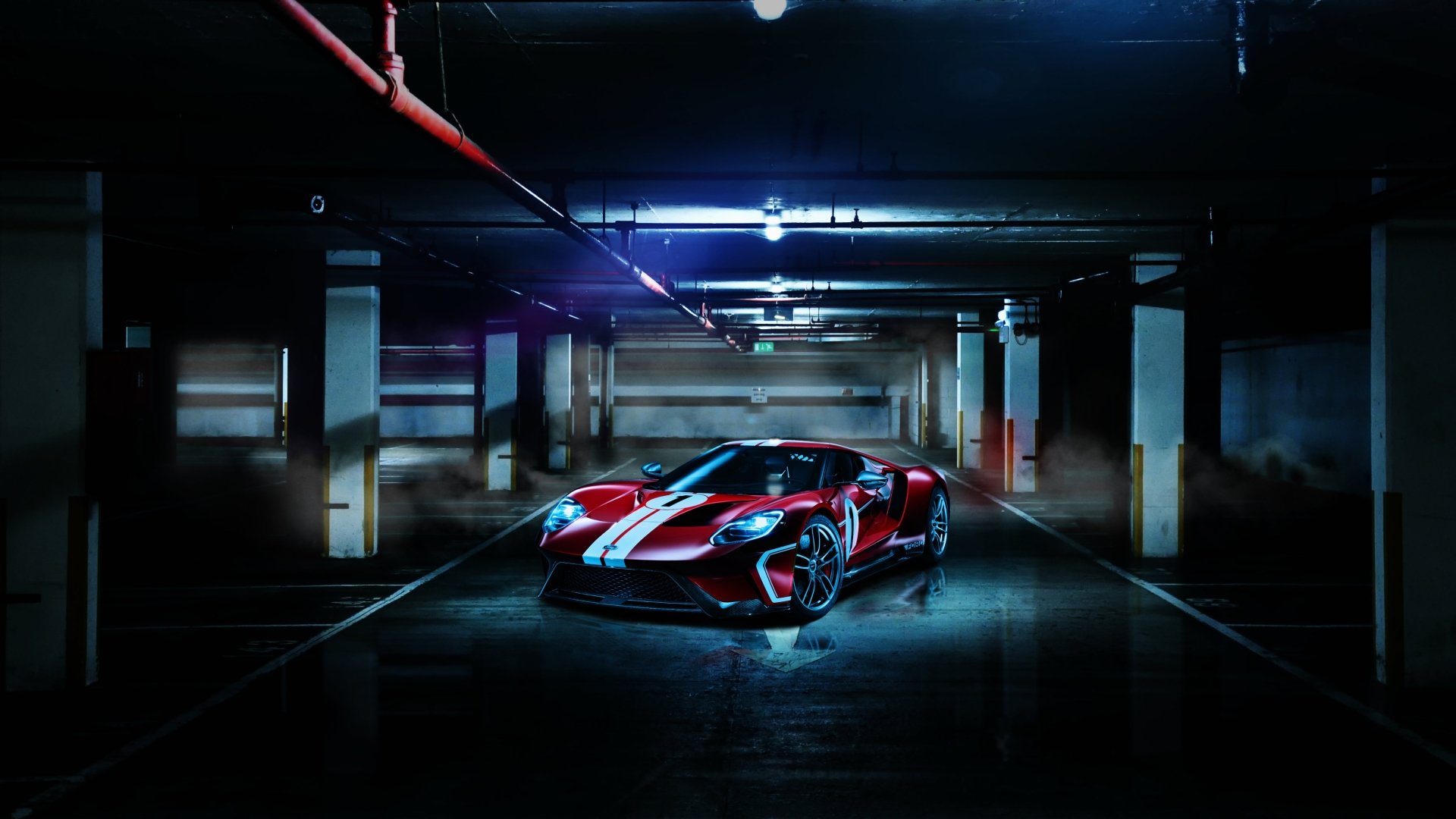 4K Ultra HD PC desktop wallpaper/background: red Ford GT supercar vehicle parked in a dim underground garage, dramatic lighting accentuating the car's racing stripes.