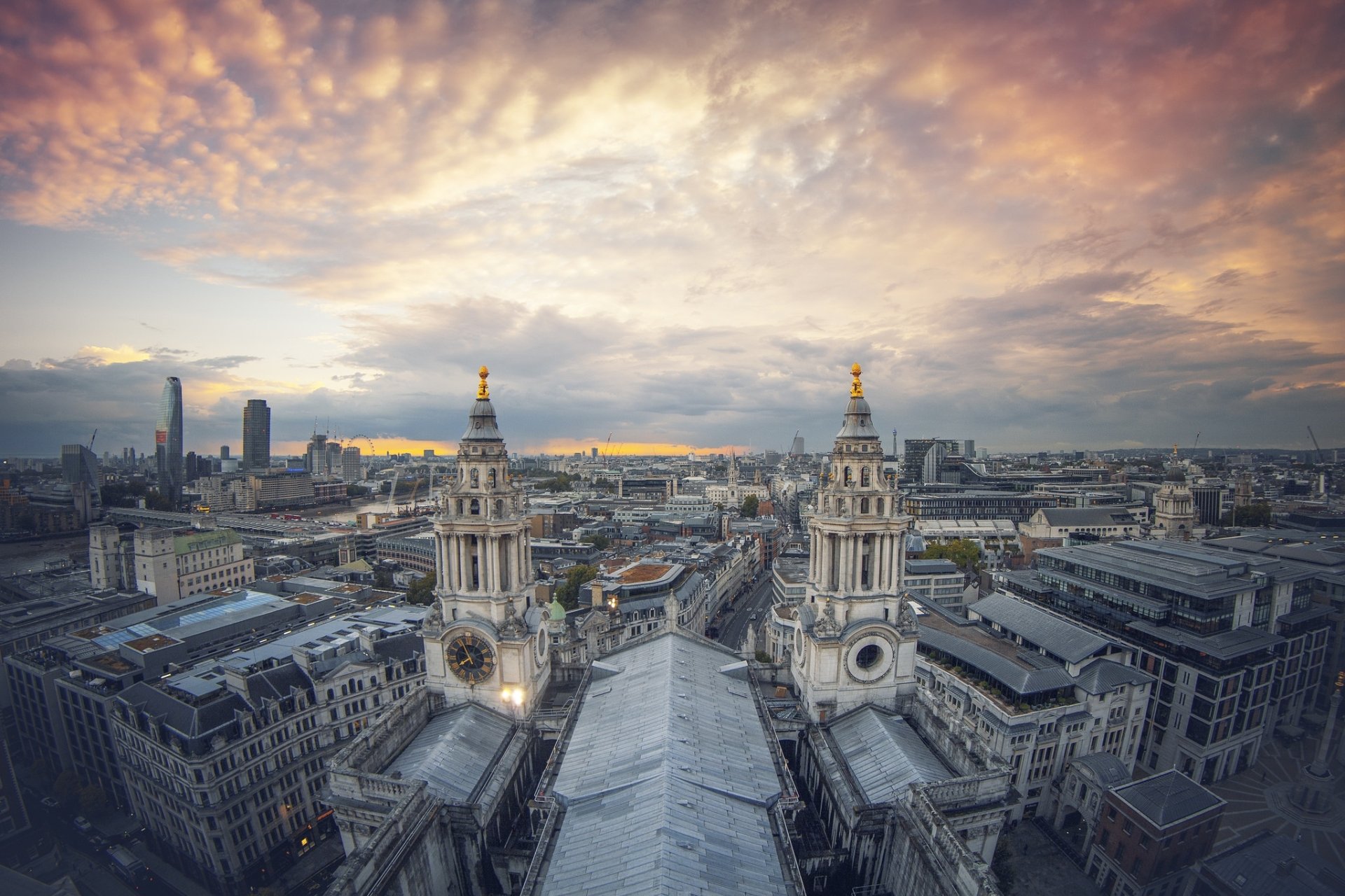 A panoramic cityscape of London, United Kingdom, featuring historic buildings under a dramatic, colorful sky, captured in HD for a PC desktop wallpaper.