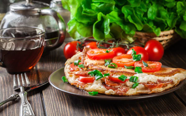 Close-up of a vibrant omelette topped with sliced tomatoes and green herbs, set on a plate with fresh tomatoes and lettuce in the background, captured in 4K Ultra HD.