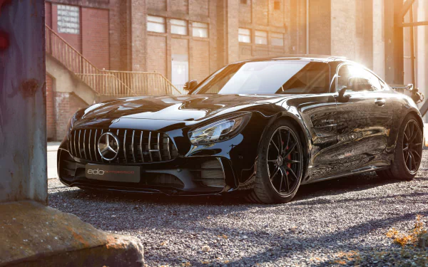 Black Mercedes‑Benz AMG vehicle parked in a sunlit industrial courtyard, rendered in high-detail 4K Ultra HD PC desktop wallpaper and background.