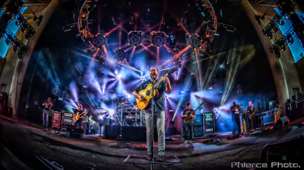 Dave Matthews Band in concert with vibrant stage lighting, serving as a dynamic HD wallpaper for desktop backgrounds.