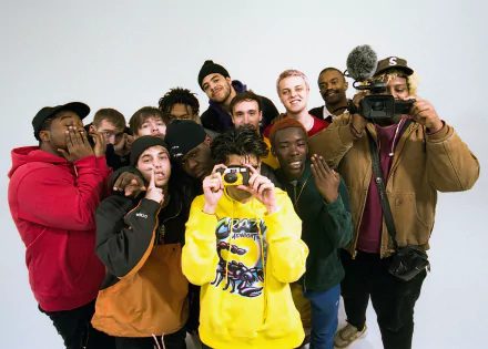 HD desktop wallpaper featuring a group photo of the music band tagged as 'BrockHampton', with members posing playfully against a white background.
