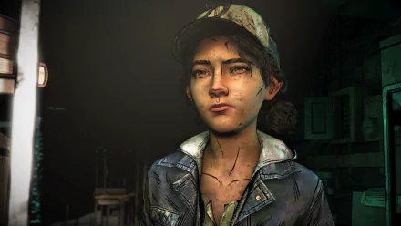 Clementine from The Walking Dead: The Final Season—close-up portrait with dirt and bruises, wearing her cap and jacket in moody lighting; HD PC desktop wallpaper/background, video game art.