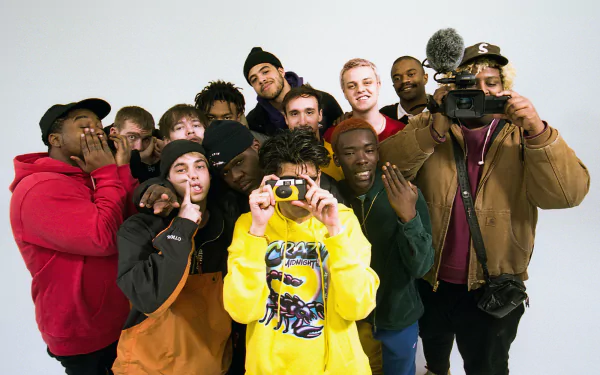 HD desktop wallpaper featuring a group photo of the music band tagged as 'BrockHampton', with members posing playfully against a white background.