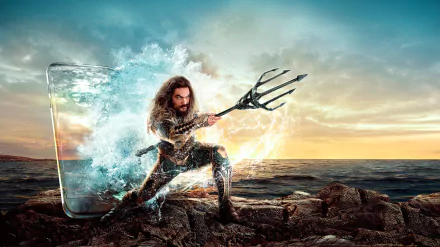 HD PC desktop wallpaper featuring Jason Momoa as Aquaman wielding his trident, emerging from a splash of water against a dramatic ocean sunset background.