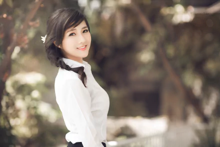 A smiling Korean woman with black hair braided to the side, wearing a white blouse. The background is softly blurred, creating a depth of field effect. This HD image is used as a desktop wallpaper.