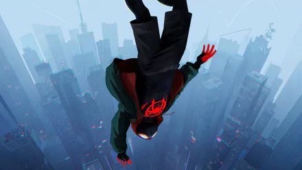 HD desktop wallpaper featuring Miles Morales as Spider-Man from the movie Spider-Man: Into The Spider-Verse, falling upside down against a backdrop of a cityscape.