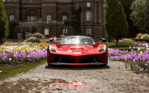 A red Ferrari LaFerrari showcased in 4K Ultra HD on a PC desktop wallpaper from the video game Forza Horizon 4, set on a flower-lined path with a historic building backdrop.