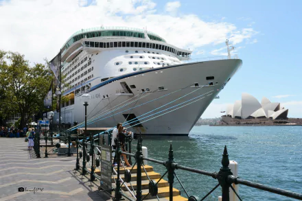 HD desktop wallpaper featuring the cruise ship MS Explorer of the Seas docked in Sydney with the Sydney Opera House visible across the water under a blue sky.