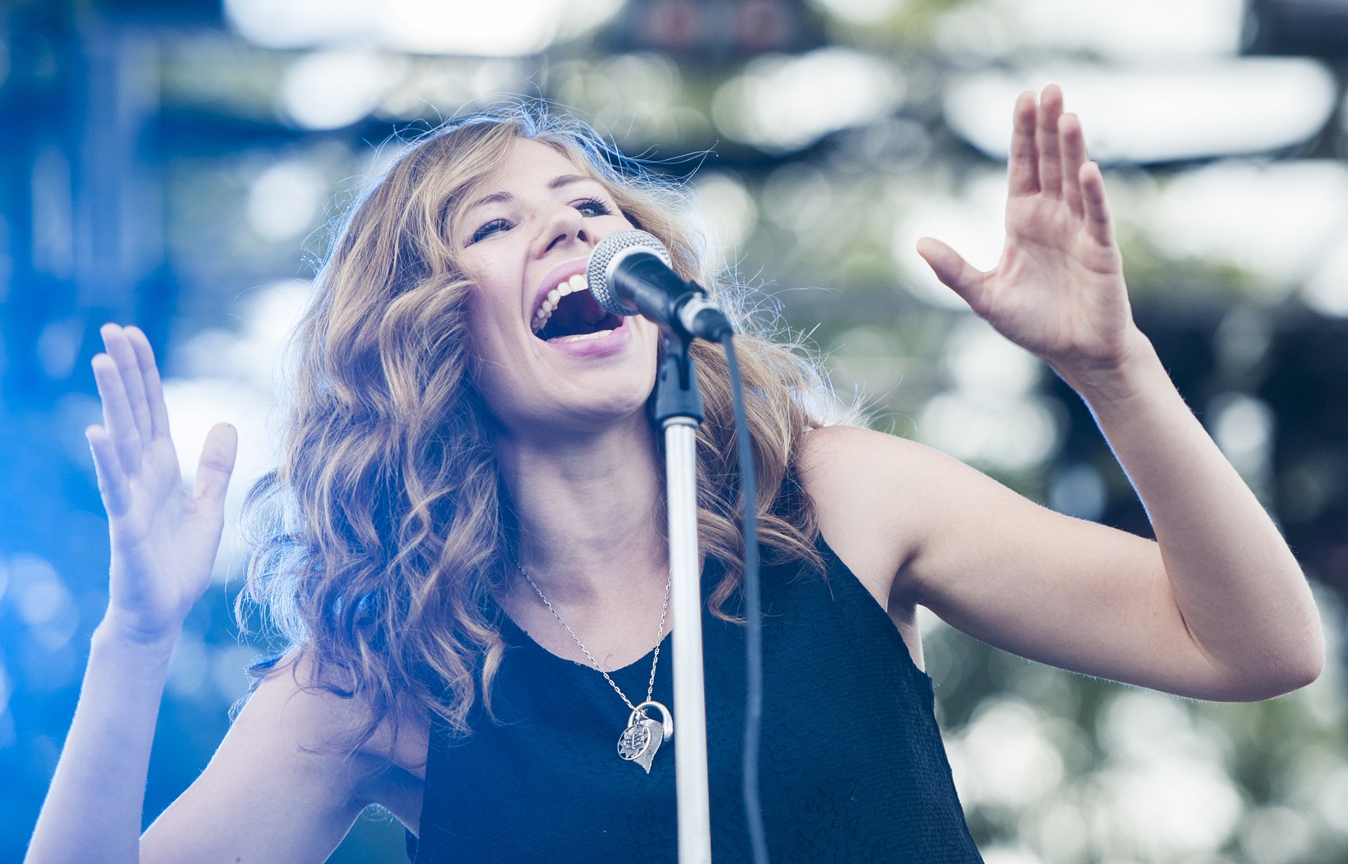 HD desktop wallpaper featuring a Lake Street Dive band member passionately singing into a microphone onstage.