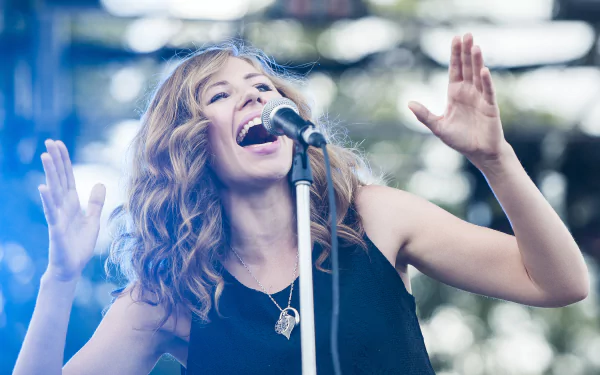 HD desktop wallpaper featuring a Lake Street Dive band member passionately singing into a microphone onstage.