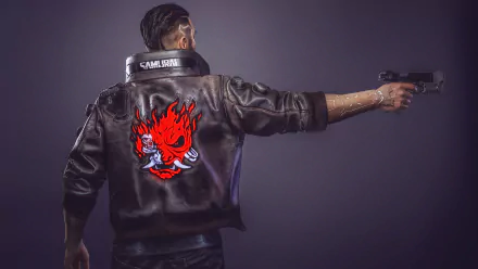 A HD wallpaper of Cyberpunk 2077 featuring a character with a flaming skull design on their jacket, pointing a pistol. The character has short, dark hair and stands against a minimalist background.