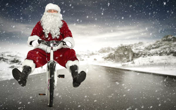 Santa Claus pedals a bicycle through falling snow on a wintry road — Christmas holiday scene, 8K Ultra HD PC desktop wallpaper/background.