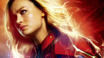 HD desktop wallpaper of Brie Larson as Captain Marvel from the movie Captain Marvel, featuring a powerful and intense look against a fiery backdrop.