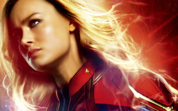 HD desktop wallpaper of Brie Larson as Captain Marvel from the movie Captain Marvel, featuring a powerful and intense look against a fiery backdrop.