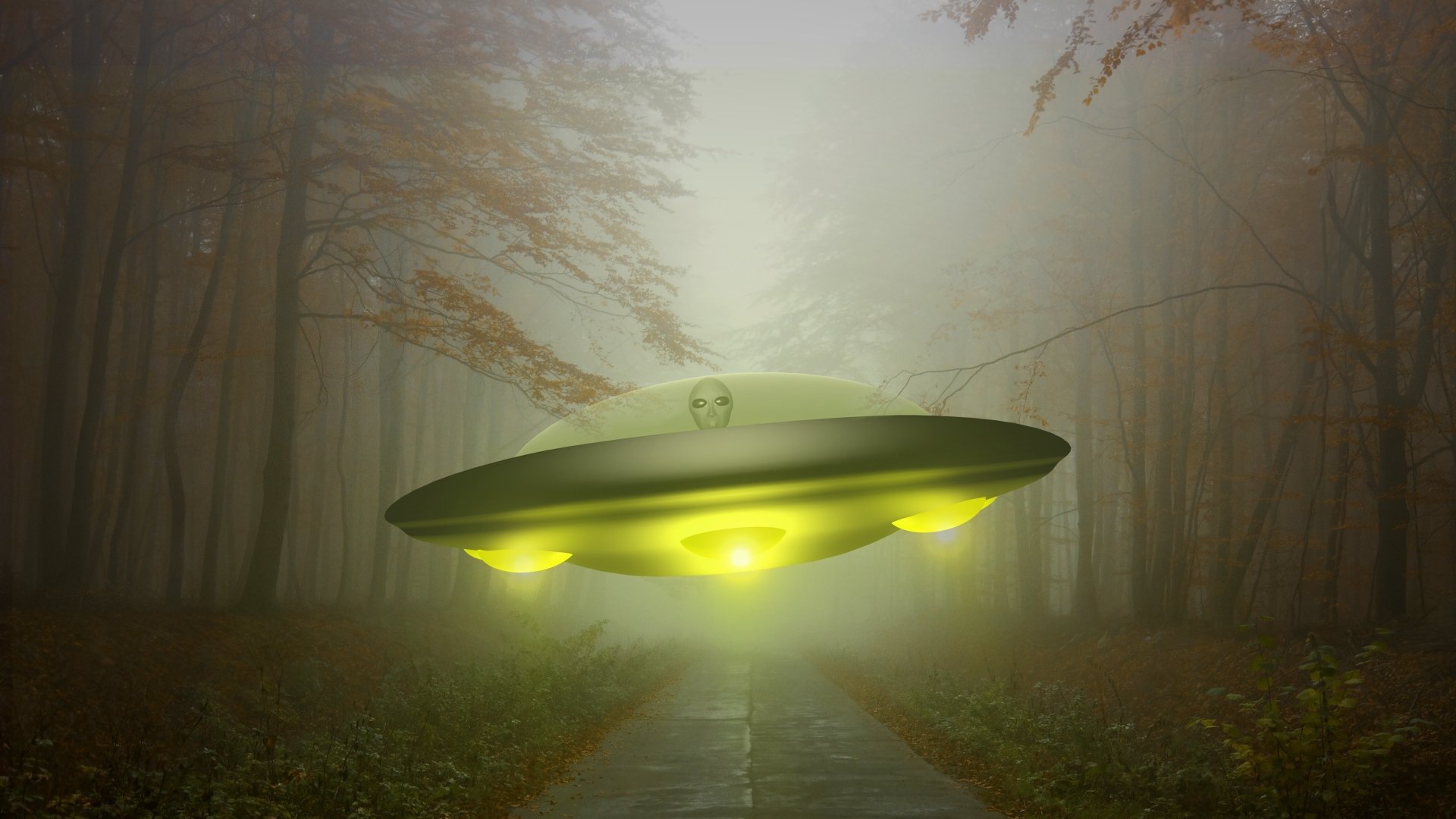 A glowing UFO spaceship hovers above a foggy forest road in this 4K Ultra HD Sci-Fi desktop wallpaper.